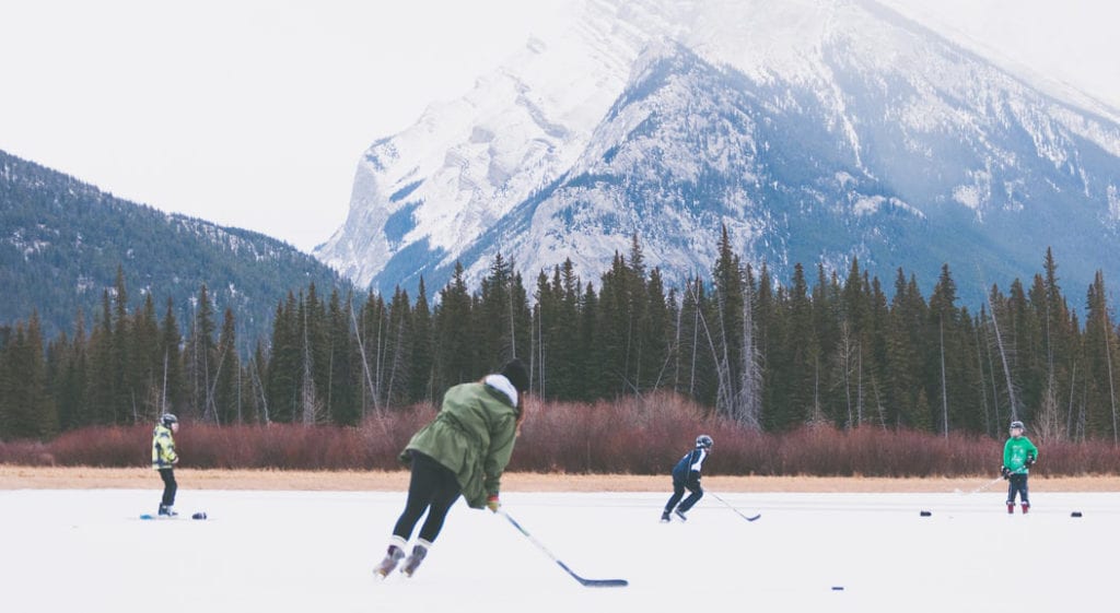 playing hockey outside with a mountain