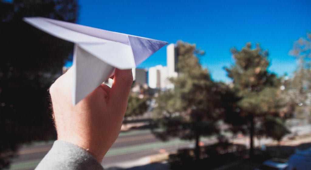 child with paper airplane