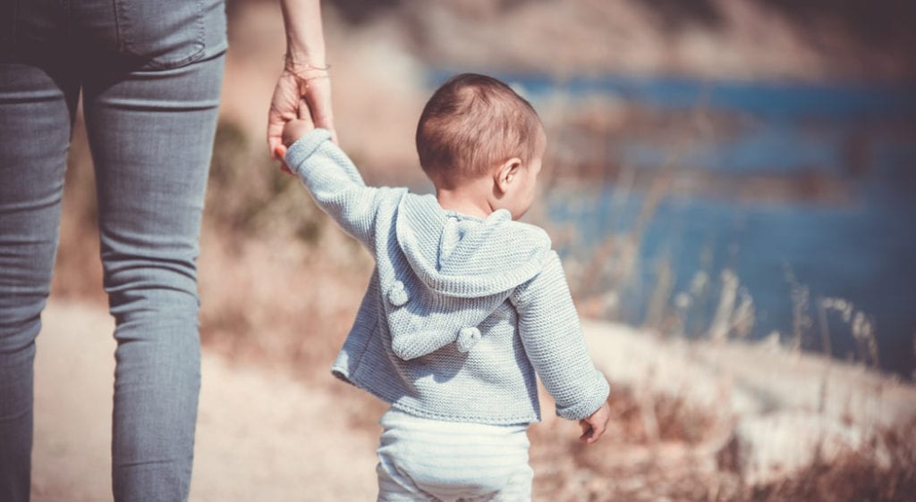 child and parent outside for a walk